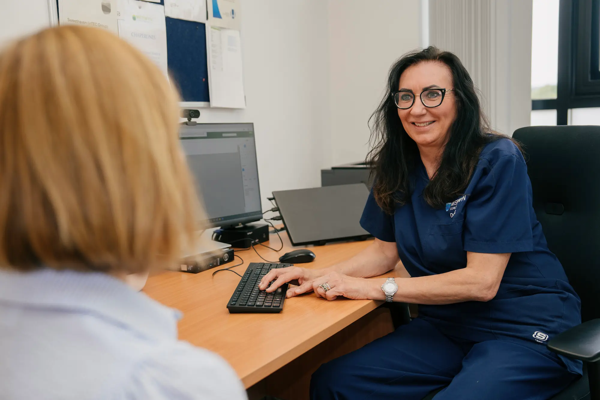 A Medwyn occupational health clinician discussing a management referral with an employee at our Surrey clinic